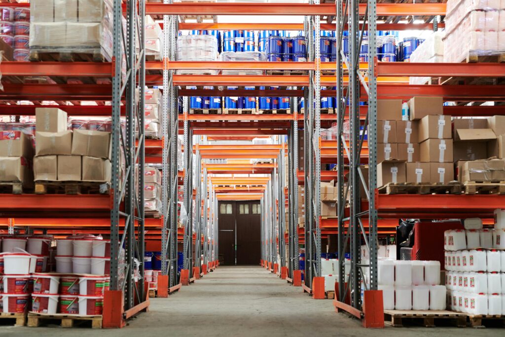 pexels photo 4483610 4483610 Wide angle view of a warehouse with stocked shelves and boxes.
